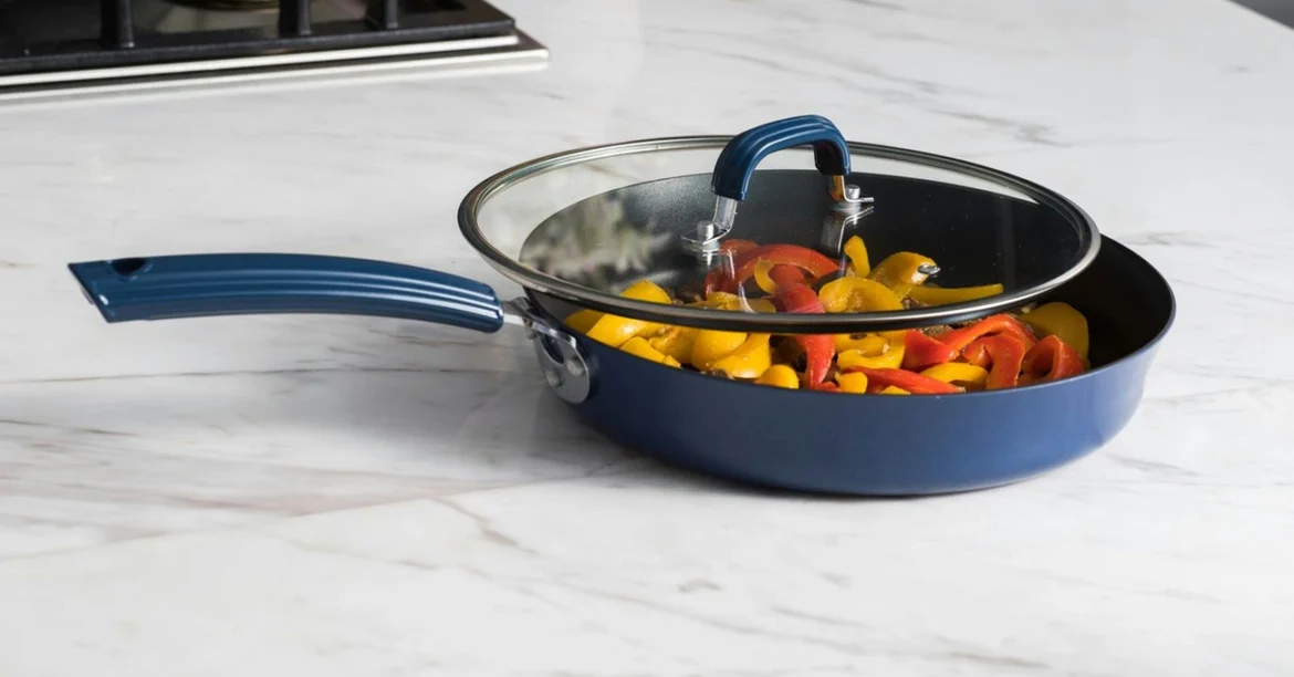 The Best Fry Pan — A premium fry pan on a modern stovetop beside fresh vegetables, eggs, and cooking utensils in a bright, contemporary kitchen.